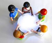5 people meeting around a table
