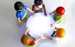 5 people meeting around a table