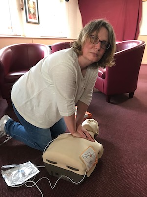 Councillor Jess Bailey attempting CPR on the training dummy during training